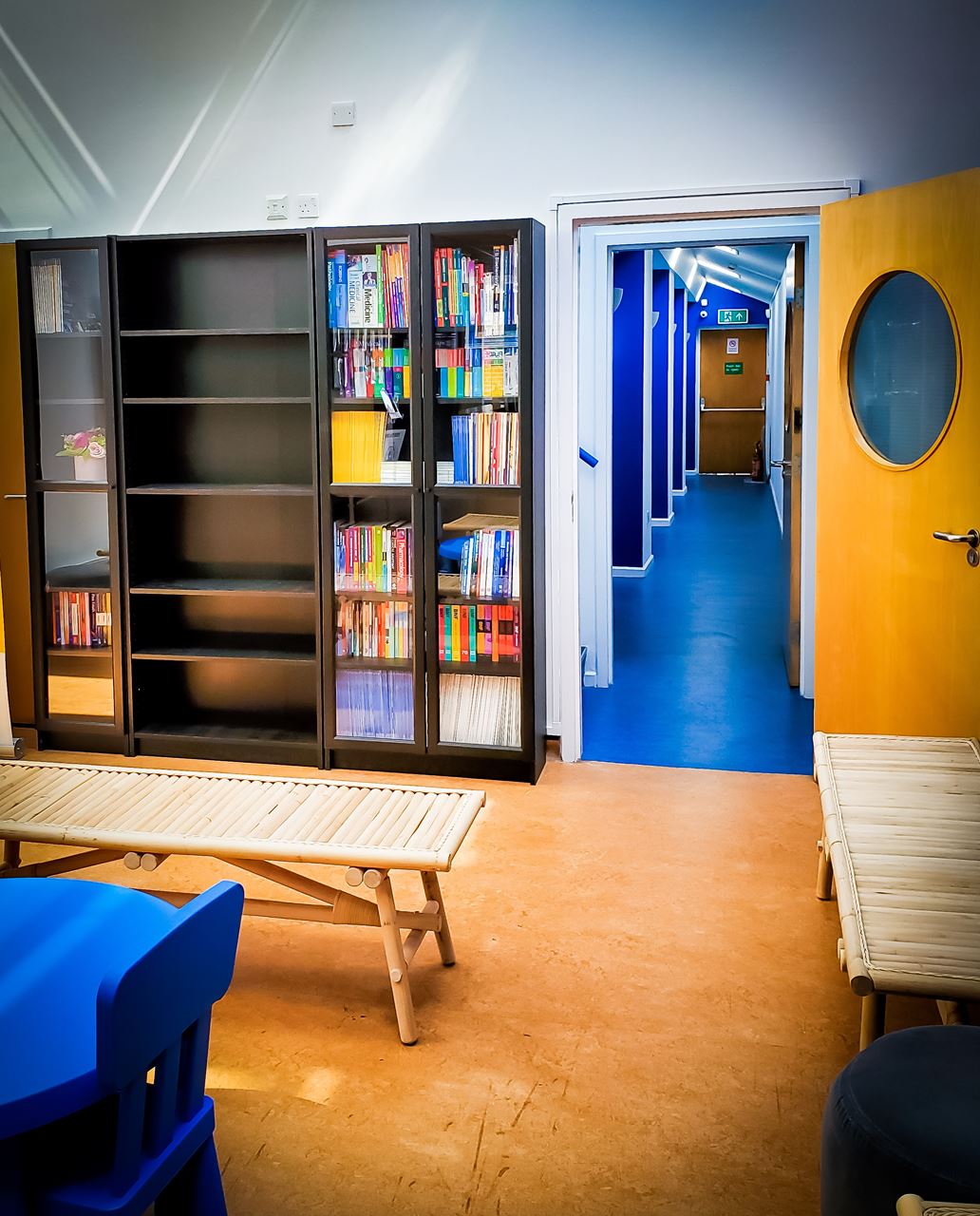 Strouts Place Medical Centre Interior Bookshelf Book Interior Decorarion Waiting Room Area Corridor Blue NHS Door Bench